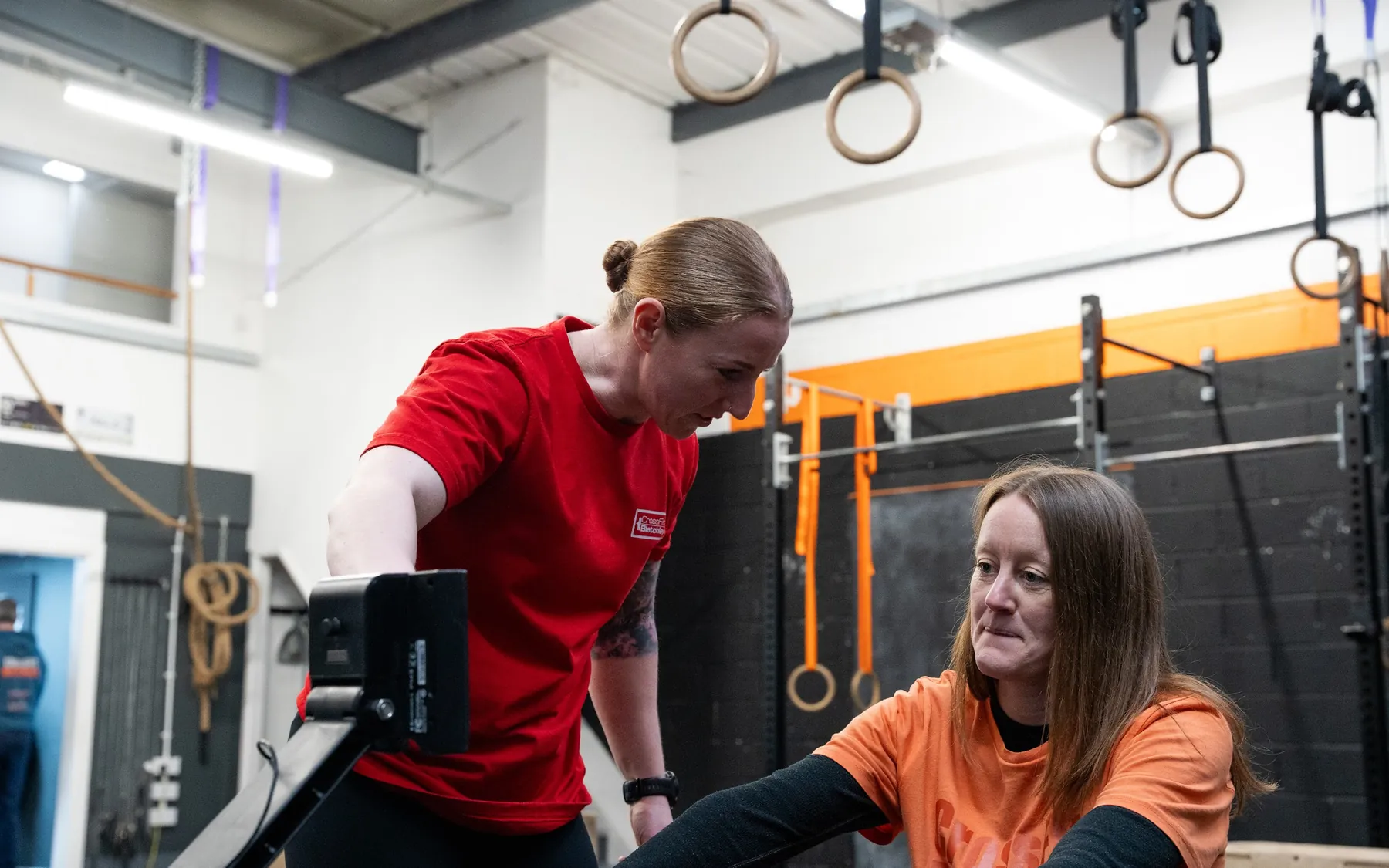 A coach correcting a member's rowing technique