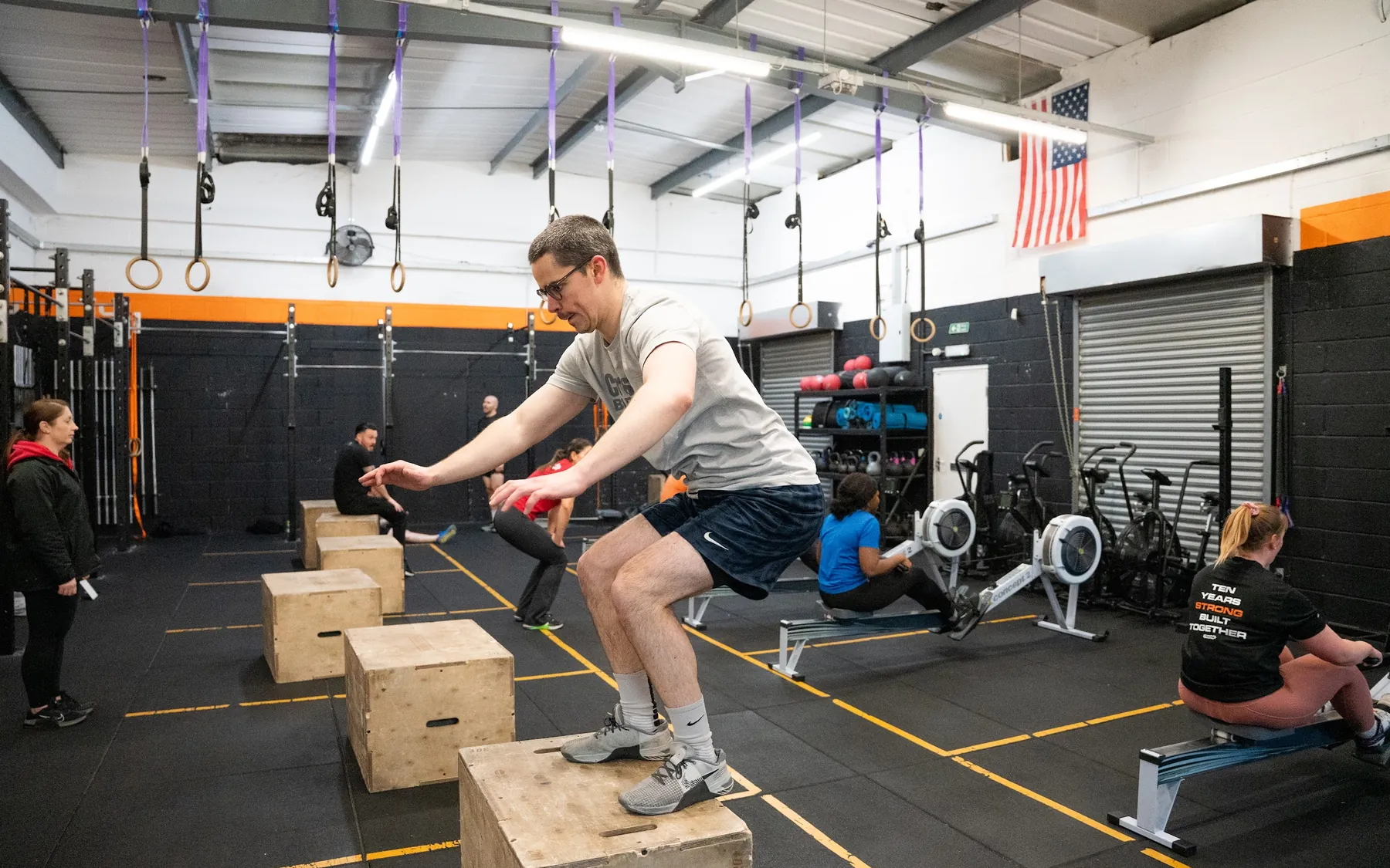 A class in progress at CrossFit Bletchley: box jumps, rowers and the rig